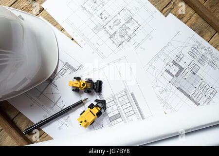 Blueprints, Hardhat or safty helmet, Pen in architecture office retro style Stock Photo