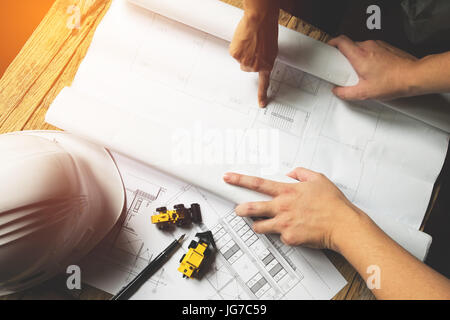 Creative architect projecting on the big drawings in the dark loft office with dark and retro style Stock Photo