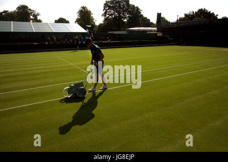 London, UK. 04th July, 2017. A bellboy chalks the line of one of the outside courts at the All England Lawn Tennis Club as preparation for day 2 of Wimbledon. Credit: Adam Stoltman/Alamy Live News Stock Photo