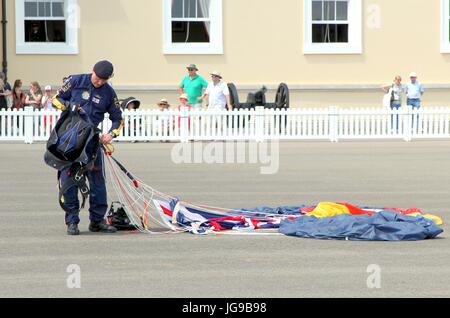 Sandhurst, Surrey, UK - June 18th 2017: Parachutist of the RLC Silver Stars Parachute Display Team retrieving his parachute after landing on the Parad Stock Photo