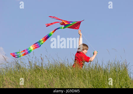 young boy flying kite, Bleckede, Lower Saxony, Germany Stock Photo