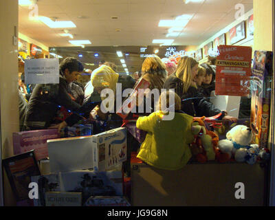 Christmas toy sale mad rush viewed from the street through window Stock Photo