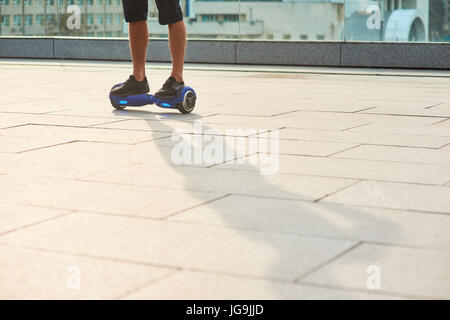 Legs of man on gyroboard. Stock Photo