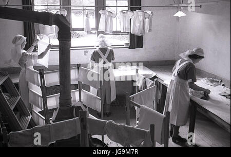 1940, England, wartime, Stanstead Hall, home of Lady Butler ( Sydney Courtauld) wife of Rab Butler, Conservative politician, picture shows female domestic staff doing the laundry and preparing the clothes for large number of the child evacuees arriving from London. Stock Photo