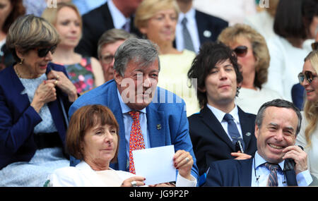 Stephen Fry and Elliott Spencer (right) in the Royal Box on day two of the Wimbledon Championships at The All England Lawn Tennis and Croquet Club, Wimbledon. Stock Photo