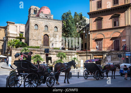 Horse and carriages waiting on the Via Maqueda  by Piazza Bellini and San Cataldo church. Palermo, Sicily, Italy. Stock Photo