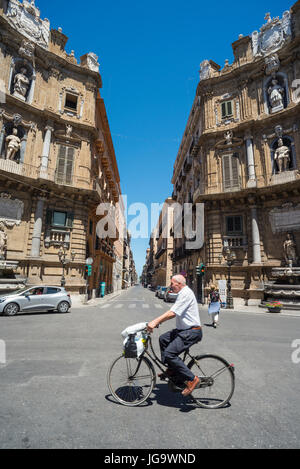 A cyclist rides through  the Quattro Cante crossroads on Corso Vittorio Emanuele with its 17th cen.  Baroque facades.   central Palermo, Sicily, Italy Stock Photo