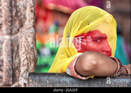 Young beautiful Indian girl waiting for the bus in traditional colored clothes, sari Stock Photo