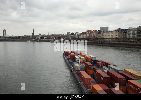 Selfpropelled container cargo boat at Rhyne river, passing through city of Dusseldorf, North Rhyne Westphalia, Germany; Stock Photo