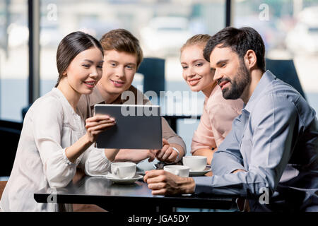 business team on meeting discussing project with digital tablet in cafe, business lunch concept Stock Photo