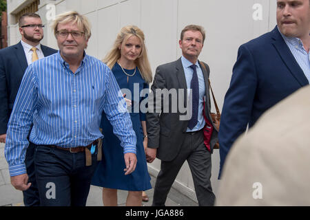 Conservative MP Craig Mackinlay, with his wife Kati Mackinlay, (both centre) leave Westminster Magistrates' Court in London where he faced charges over his 2015 general election expenses. Stock Photo