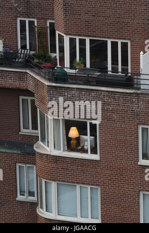 Single Lamp in Window, Midtown Manhattan, NYC, USA Stock Photo