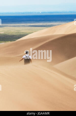 Visitors in wind blown sand explore the Great Sand Dunes National Park & Preserve; San Luis Valley; Colorado; USA. Tallest sand dunes in North America Stock Photo