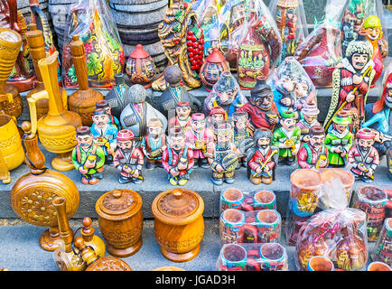 The handmade souvenirs in market stall - statuettes, carved wooden cups and bottles, Svan wool hats, Tbilisi, Georgia. Stock Photo