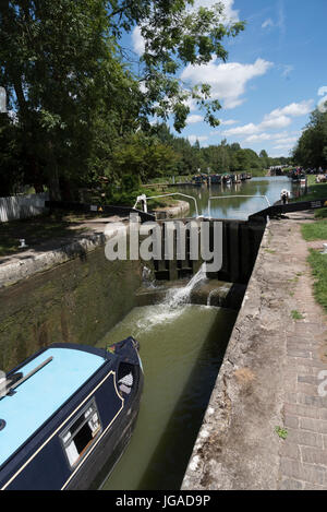 Canalboat passing through a lock on the top of  Caen Hill Flight of locks at Devizes Wiltshire,England UK Stock Photo