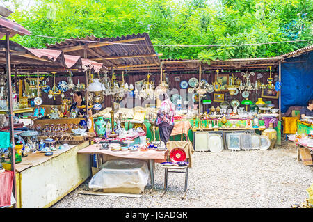 TBILISI, GEORGIA - JUNE 6, 2016: The antique porcelain dishware, chandeliers, lamps, paintings and other interesting goods in stalls of the Flea Marke Stock Photo