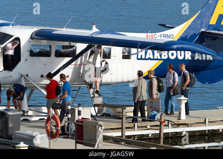 Passengers Preparing To Board A Harbour Air Seaplanes Turbo Otter Floatplane At The Vancouver Harbour Flight Centre, British Columbia, Canada. Stock Photo