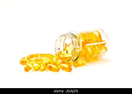 Fish oil, omega 3 with vitamin D capsules good for heart health  in a bottle and on white table. Stock Photo