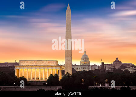 New Dawn over Washington - with 3 iconic monuments illuminated at sunrise: Lincoln Memorial, Washington Monument and the Capitol Building.