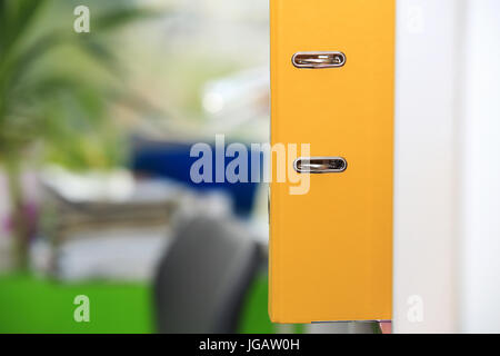 Yellow folder close-up on office background. Folder for documents. Stock Photo