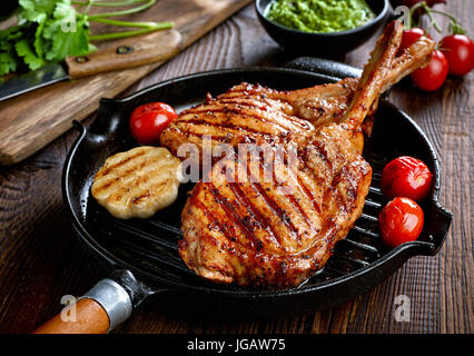 Freshly grilled Tomahawk steak on grilling pan Stock Photo