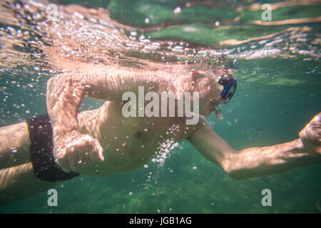 Middle aged man enjoying reef in Indian Ocean, Kenya Stock Photo