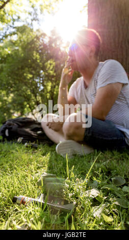 Young man smoking cigarette with electronic cigarette on foreground Stock Photo