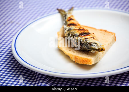 Grilled sardine on slice of bread, Portugal Stock Photo