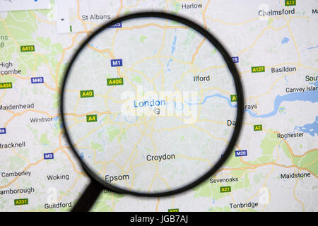 Map of London on Google Maps under a magnifying glass. London is the capital city of the United Kingdom. Stock Photo