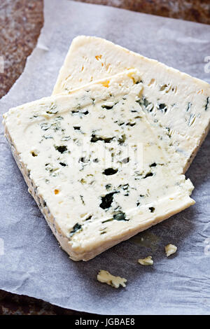 Two slices of blue cheese on white parchment paper Stock Photo