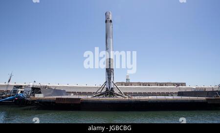 The SpaceX Falcon 9 first stage rocket returns to the Port of Los Angeles aboard the 'Just Read the Instructions' autonomous spaceport drone ship June 28, 2017 in Hawthorne, California. The rocket successfully carried the Iridium-2 payload into orbit from the before landing on the Pacific Ocean sea going drone ship. Stock Photo