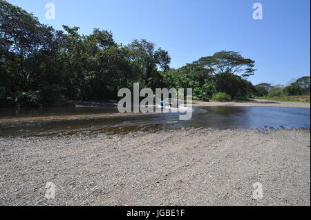 Driving through a river costa rica Stock Photo