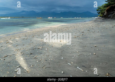 VIew to Lombok mountains from the sunny beach of Gili Air during sunset, Indonesia Stock Photo