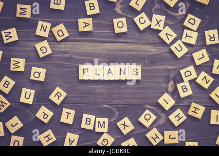 Plans word wood block on table for business concept. Stock Photo
