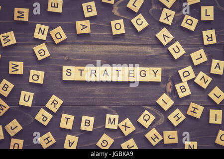 Strategy word wood block on table for business concept. Stock Photo