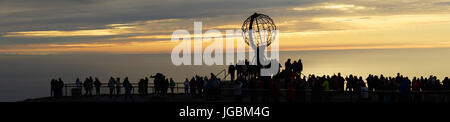 Tourists on North Cape watching midnight sun, Norway Stock Photo