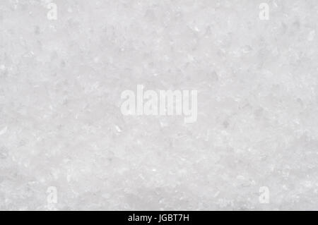 A background texture of artifical snow with icy fragments. Stock Photo