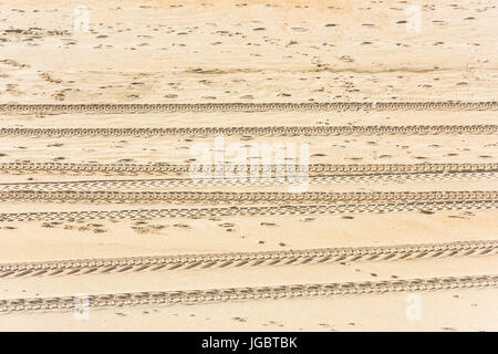 Traces of car tires on the sand as a background Stock Photo