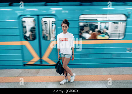 Beautiful young girl posing on metro station Stock Photo