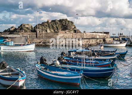 Moored  fishermen boats at the port of Aci Trezza in cold and windy winter day. Stock Photo
