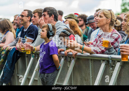 Thornhill, Scotland, UK - August 26, 2016: Festival goers standing at the barrier in front of the main stage of the Electric Fields festival Stock Photo