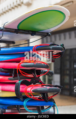 set of different color surf boards in a stack. France Stock Photo