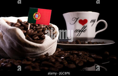Portuguese flag in a bag with coffee beans isolated on black background Stock Photo