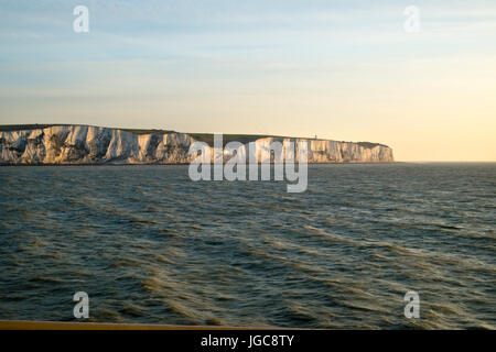 An early morning cross channel ferry passes the white cliffs of Dover, Kent, UK heading for Calais, France. Stock Photo