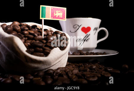 Sri Lankan flag in a bag with coffee beans isolated on black background Stock Photo