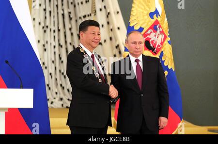 Russian President Vladimir Putin congratulates Chinese President Xi Jinping after awarding him the Order of St Andrew the Apostle during a ceremony at the Grand Kremlin Palace July 4, 2017 in Moscow, Russia. The Order of St. Andrew the Apostle the First-Called is the highest order of the Russian Federation established by the Russian Empire in 1698. Stock Photo
