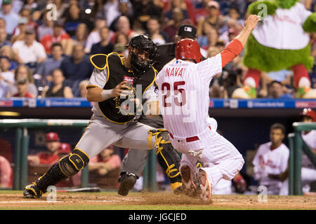 Pittsburgh Pirates Francisco Cervelli (29) and home plate umpire DJ  Reyburn, left, react after both being hit by a pitch as Toronto Blue Jays  catcher Dioner Navarro, centre, looks to help during