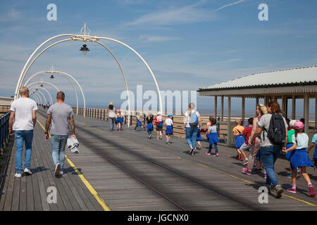 Southport, Merseyside, UK. UK Weather.  6th July, 2017. Bright sunshine in the resort as people and school children, on a day out, enjoy the sunny weather and a walk on the Victorian pier. Credit;MediaWorldImages/AlamyLiveNews Stock Photo