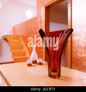 Glass sculpture by bottle and candle holders Stock Photo