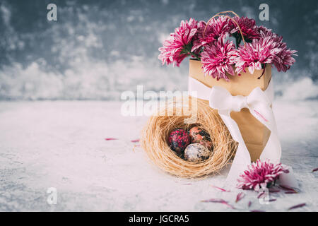 Flowers and painted Easter eggs in a nest Stock Photo